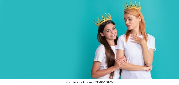 Mother And Daughter Child Banner, Copy Space, Isolated Background. Selfish Woman Mother Smile At Happy Girl Child In Crowns Blue Background, Daughter.