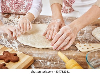 Mother And Daughter Cooking Christmas Biscuits