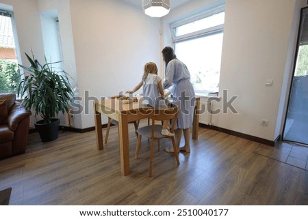 Similar – Carer wearing slippers to elderly female patient