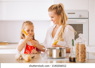 Mother And Daughter Cooking Pasta