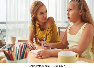 Mother And Daughter Discussing Essay Topic Before Writing