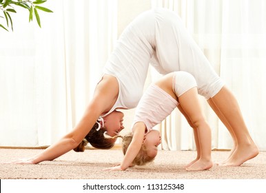 Mother and daughter doing exercise home - Powered by Shutterstock