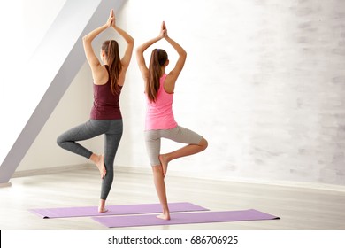 Mother And Daughter Doing Exercise Indoors