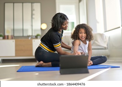 Mother and daughter doing fitness exercices at home