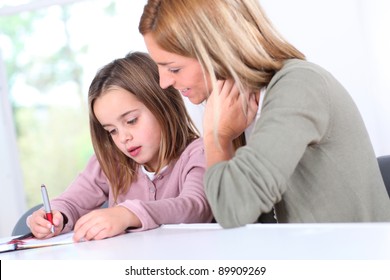 Mother And Daughter Doing Homework At Home