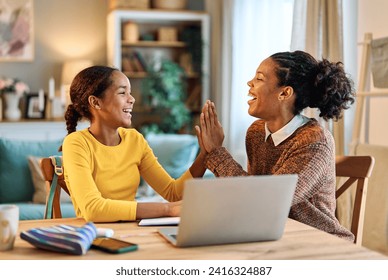 Mother and daughter doing homework with laptop at home. Mom and teenage girl happy using laptop. Teen girl and mum sitting at home working with notebook - Powered by Shutterstock