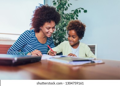 Mother and daughter doing homework learning to calculate