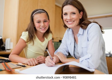 Mother And Daughter Doing Homework Together