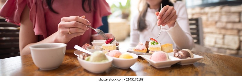 Mother And Daughter Eating A Lot Of Sweets