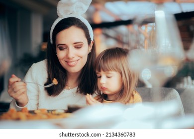 

Mother and Daughter Eating Together Celebrating Easter. Traditional family dinner spending quality time with the loved ones

 - Powered by Shutterstock