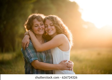Mother and daughter embracing each other