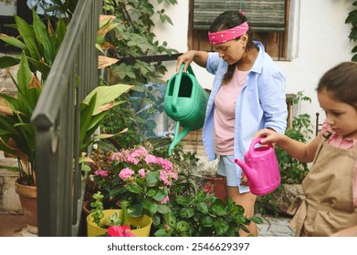 A mother and daughter engage in gardening, watering vibrant flowers and plants. Their joyful collaboration reflects family bonding and appreciation of nature. - Powered by Shutterstock