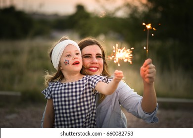 Mother And Daughter Enjoy Fourth Of July Sparklers Together