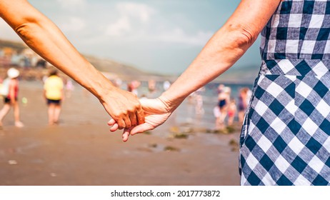 Mother and daughter enjoy their holidays on the beach in Lyme Regis, United Kingdom. Multigenerational family is joyful and reunited during their summer holidays - Powered by Shutterstock