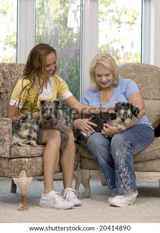 mother and daughter enjoying time with their dogs