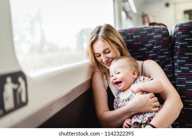 Mother and daughter enjoying trip on the train.