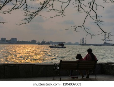 Mother and daughter enjoys sunset in marine drive kochi.