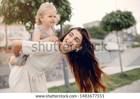 Mother with daughter. Family in a park. Cute little girl