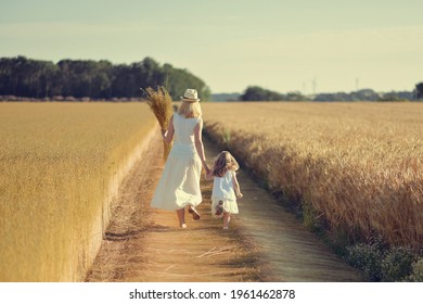 Mother and daughter in the field while harvesting flax Dry linen
