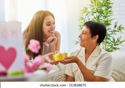 Mother And Daughter With Gift