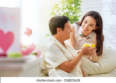 Mother And Daughter With Gift