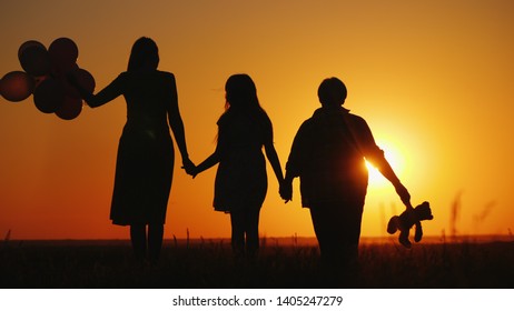 Mother daughter and grandmother together admire the sunset. Active seniors concept