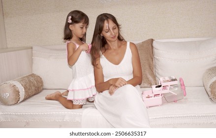   mother and daughter hair brushing eachother making hair style using hair acssessaries                              - Powered by Shutterstock