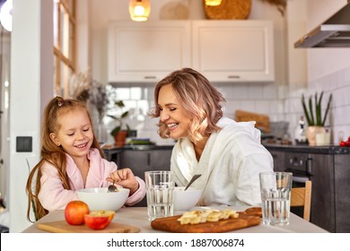 Mother And Daughter Have Breakfast In The Kitchen At Home, Beautiful Family Sit Together Having Meak, Enjoying Morning Together, Have Fun, Smile