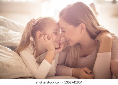 Mother and daughter have a strong connection. Mother daughter in bed. - Powered by Shutterstock