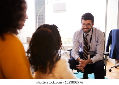 Mother And Daughter Having Consultation With Male Pediatrician In Hospital Office