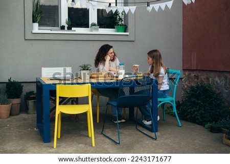 Mother and daughter are having a conversation n the backyard Foto stock © 