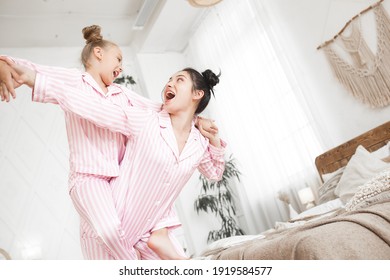 Mother and daughter having fun at home. Girls indoors.