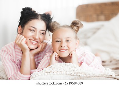 Mother and daughter having fun at home. Girls indoors.