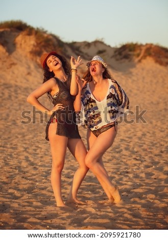 Mother and daughter having fun on tropical beach at sunset - Mum playing with her teenage child in holiday vacation on the sandy coast in sunny day - Family lifestyle, travel and love concept