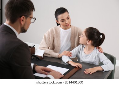 Mother and daughter having meeting with principal at school