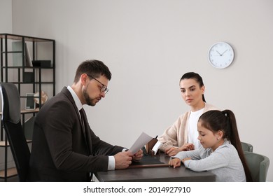 Mother and daughter having meeting with principal at school - Shutterstock ID 2014927910