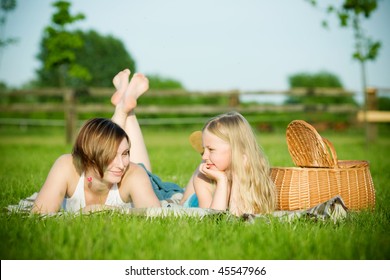 Mother and daughter having picnic