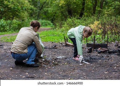 Mother and daughter helping clean up the forest in Elk Island National Park.