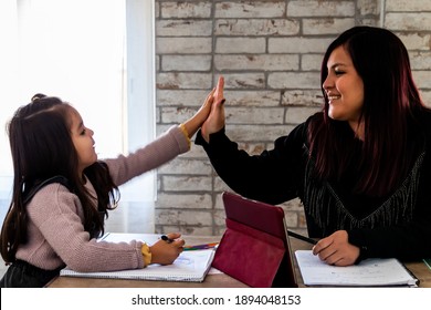 Mother and daughter high-fiving for homework well done - Powered by Shutterstock