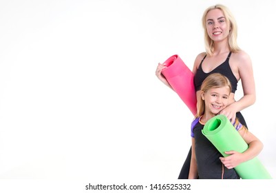 Mother And Daughter Holding Yoga Mats, Isolated On White. Sport, Family, Health Concept