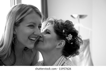 Mother And Daughter Kissing Before The Wedding.