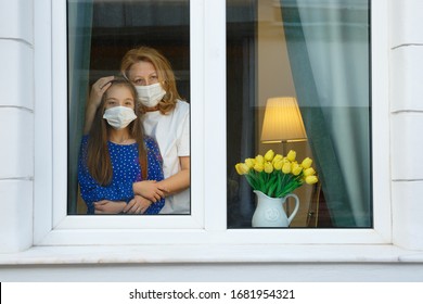 Mother and Daughter looking out for the quarantine to finish as soon as possible - Shutterstock ID 1681954321
