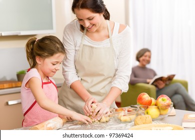 Mother and daughter making apple pie together grandmother check recipe - Powered by Shutterstock