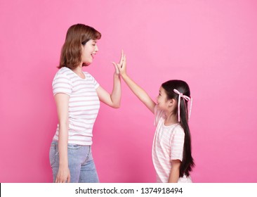 Mother And Daughter Making Hi Five Gesture