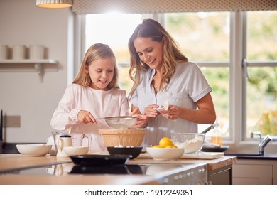 Mother And Daughter Making Pancakes In Kitchen At Home Together - Powered by Shutterstock