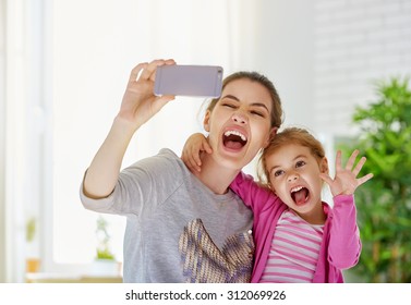 Mother And Daughter Making A Selfie