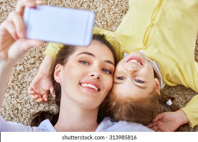 Mother And Daughter Making A Selfie