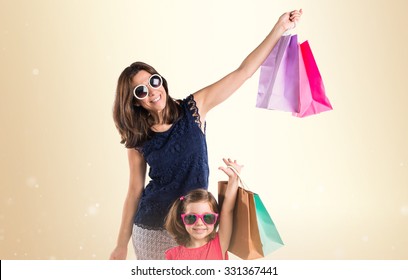 Mother And Daughter With Many Shopping Bags