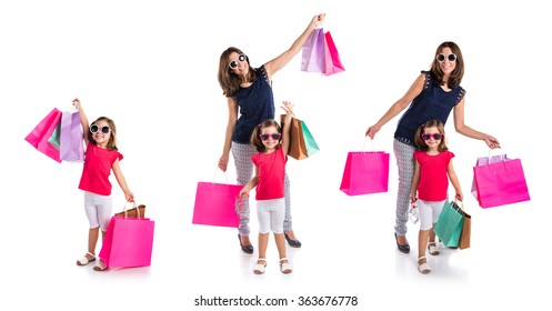 Mother And Daughter With Many Shopping Bags