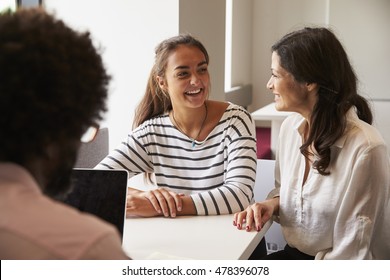 Mother And Daughter Meeting With Male Teacher